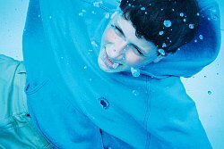 swimming in blue hoodie underwater